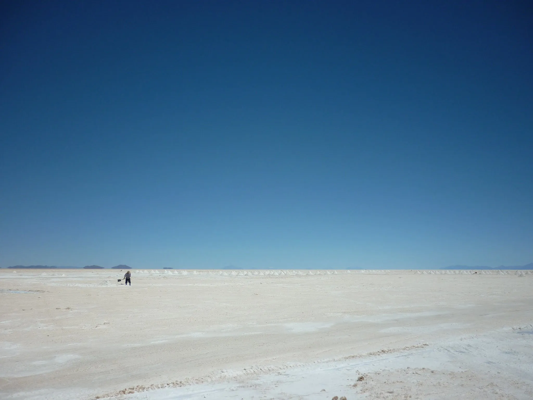 A lone salt worker in the distance